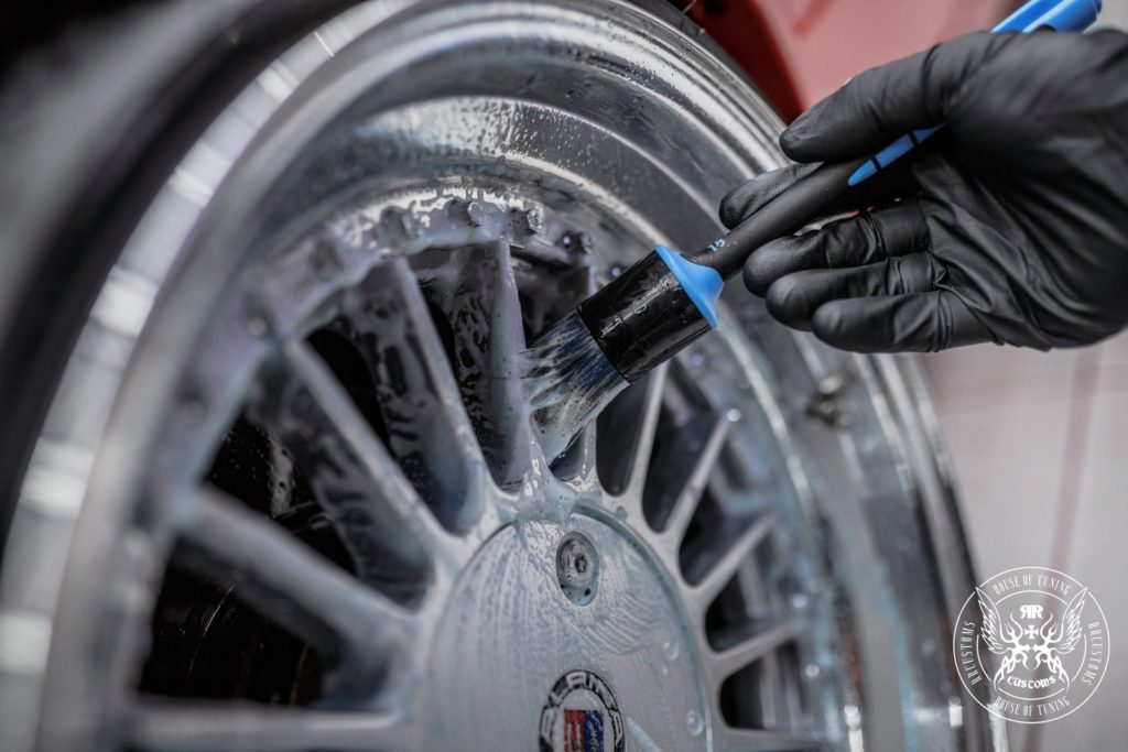 cleaning car rim with a brush