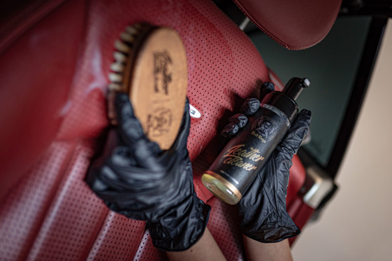 Close up of red drivers seat in Mercedes Cabrio being washed with an RRC brush using Leather Cleaner